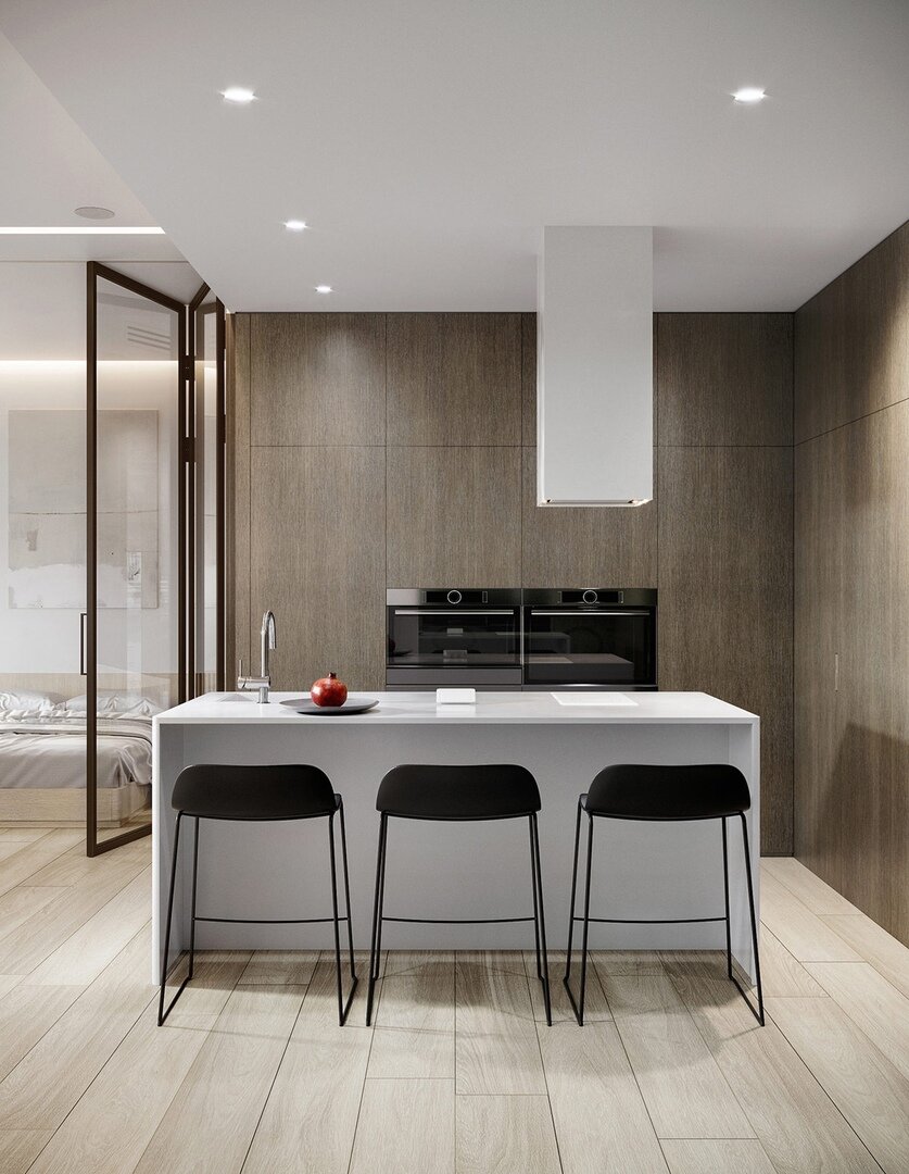 Интерьер достаточно минималистиный, но очень функциональный. Дизайнеры постарались максимально использовать каждый квадратный метр квартиры. Так, кухонный остров выполняет функции и рабочей поверхности, и обеденной зоны.
