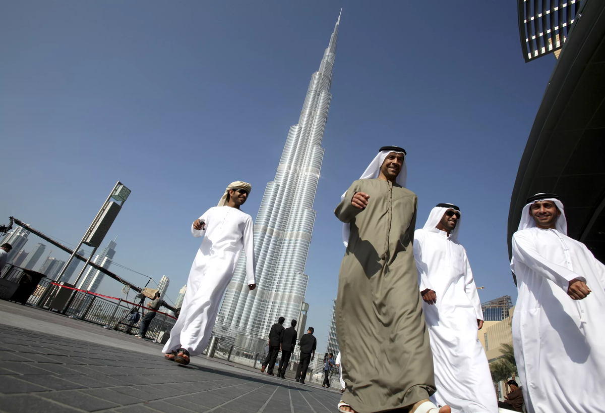 Дубай люди. ОАЭ арабы-эмиратцы. Пакистанцы в ОАЭ. Араб на фоне Бурдж Халифа. Дубай местные жители.
