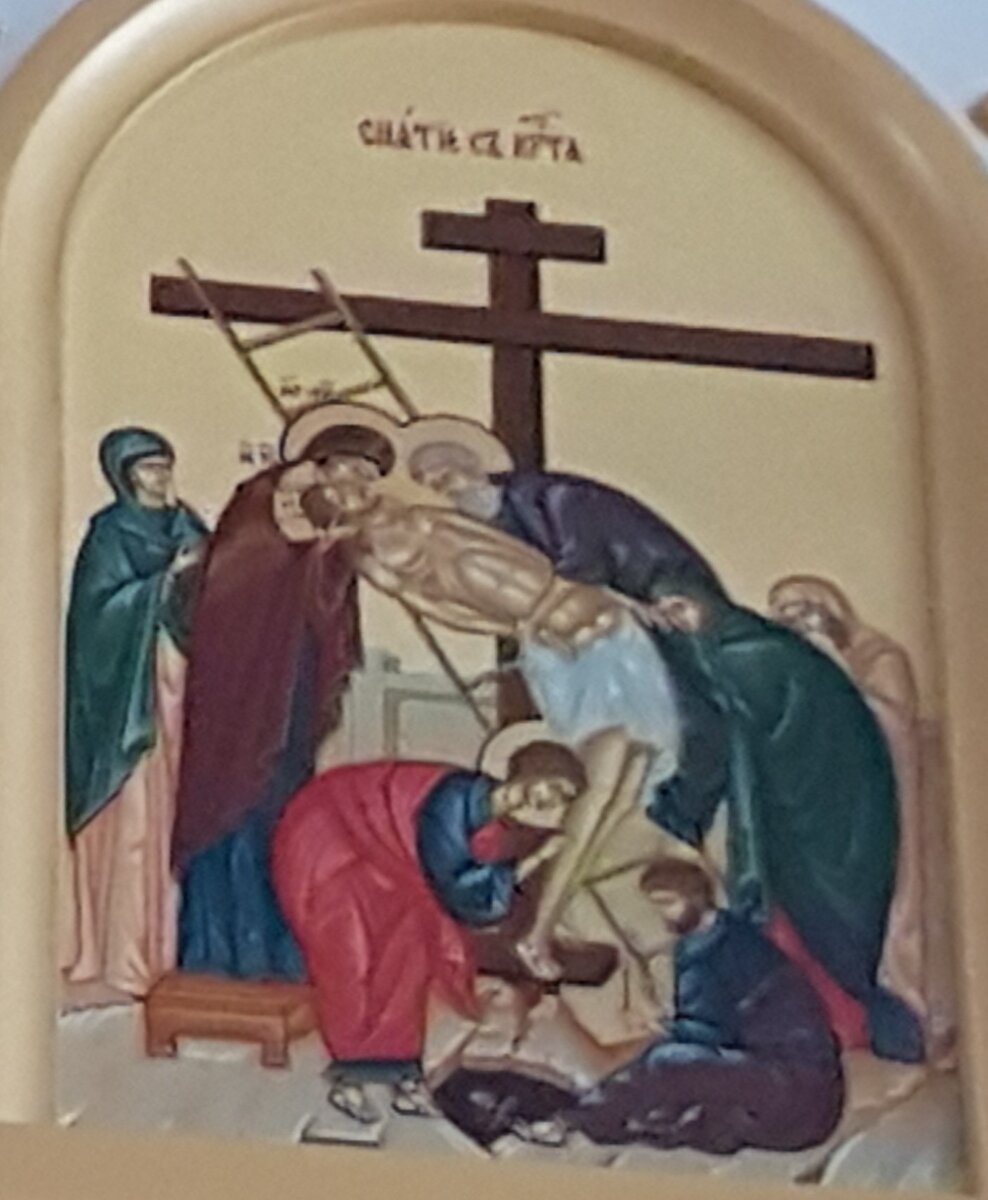 Икона "Снятие с креста" из иконостаса придела святителя Николая Мирликийского. Храм Успения Пресвятой Богородицы "за верхом" г. Калуга. В центре композиции на фоне темного креста — склоненное влево, обнаженное, мертвое Тело Христа. Справа изображены две женские фигуры  и Иосиф Аримафейский (изображен на лестнице над Христом). Слева - две выпрямленные женские фигуры. Одна из них — Богоматерь, прильнувшая щекой к щеке Сына. У подножия креста Иоанн и Никодим вынимают гвозди из ног Христа. Внизу  черное отверстие пещеры с черепом Адама. 