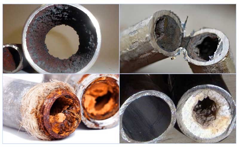 Заросшие отложениями железа водопроводные трубы