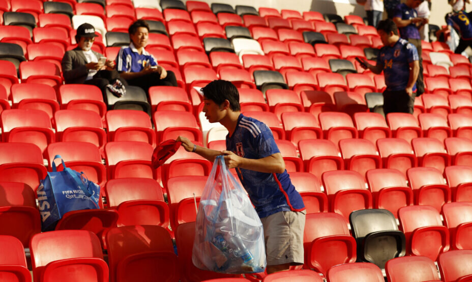    Даже расстроенные поражением японцы принялись убирать стадион в Катаре. Фото: REUTERS