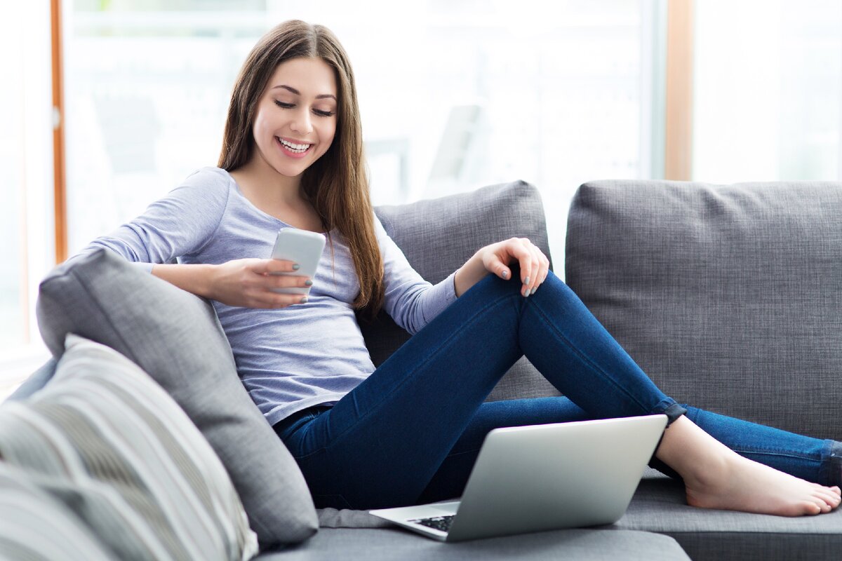 Model use. Mobile Phone on Sofa. On the Sofa with Phone. Sit on the Phone. At Home on the Sofa with smartphone.