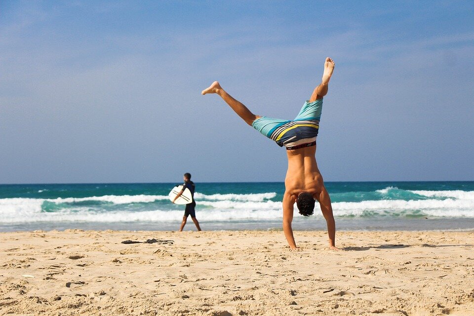 https://pixabay.com/photos/handstand-beach-sea-ocean-sand-2224104/