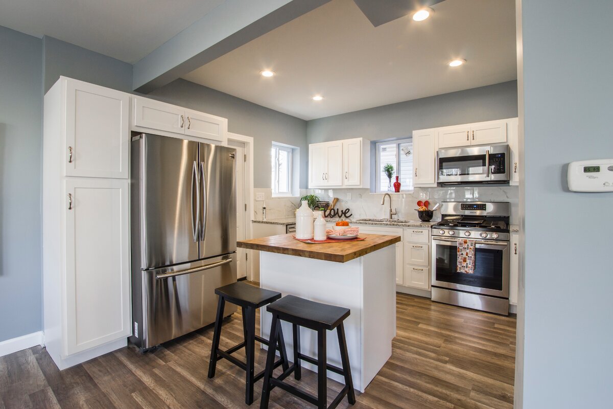 https://www.pexels.com/photo/two-black-wooden-bar-stools-near-table-and-french-door-refrigerator-1663263/