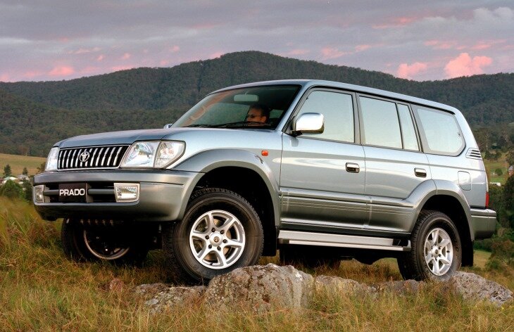 Land Cruiser Prado — среднеразмерный внедорожник японского концерна Toyota. Первое поколение появилось в 1987 году, и его важными плюсами являлись высокая проходимость при комфорте, достойном легкового автомобиля. Предлагались трёх- и пятидверные версии, которые оснащались бензиновым (1RZ) и дизельными (2L, 2LT, 3L, 1PZ, 1HZ, 1KZ) двигателями. На ряд рынков Prado 70 series поставлялся как Land Cruiser II или Light Land Cruiser. Первое поколение модели выпускалось на протяжении девяти лет. 
Второе поколение Toyota Land Cruiser Prado, получившее индекс «90», увидело свет в 1996 году. Модель заметно «подросла», по сравнению с предшественником. В основу этого поколения легла платформа Toyota 4Runner. Дизайн экстерьера был усовершенствован — кузов лишился угловатости и приобрел плавные линии. Положительными сторонами обновленного внедорожника можно назвать хорошую управляемость, проходимость, высокий уровень комфорта, а также, широкий список бортового оснащения. Land Cruiser Prado 90 также предлагался в 3- и 5-дверном вариантах кузова. Он стал первым автомобилем семейства, оснащённым независимой передней подвеской.

Под капотом устанавливались двигатели: 5VZ-FE (бензиновый) с рабочим объемом в 2,7 и 3,4 литра мощностью 150 л.с. и 178 л.с. соответственно; 1KZ-TE (турбодизель) объемом 3,0 литра мощностью 125 л.с.

Трансмиссия с полным приводом. Режимов трансмиссии несколько: Н — полный привод с работающим межосевым дифференциалом (для обычных режимов движения); HL — межосевой дифференциал заблокирован (для скользких и мокрых дорог), N — нейтральных; LL — пониженная передача и заблокированный межосевой дифференциал (для сложных условий движения). 

В июне 1999 года компания Toyota провела рестайлинг модели Prado 90. Для повышения уровня комфорта и езды были внесены некоторые изменения. В первую очередь им подверглись передняя решетка и бампер, отделка дверей и дизайн приборной панели. Были предложены разнообразные опции: система контроля за тягой Active Traction Control (TRC), система контроля за стабильностью автомобиля (VSC) и автоматическая коробка передач почти для всех комплектаций.

Просторный салон внутри смотрится уютно. Высокая посадка обеспечивает водителю отличную обзорность. Деревянные вставки на панели приборов придают ей солидности. На центральной панели располагаются вспомогательные измерительные приборы: клиномер, компас и посередине многофункциональный измерительный прибор. Клиномер отслеживает положение автомобиля относительно горизонта, шкалы проградуированы до 40 градусов. Компас показывает направление движения. Многофункциональный прибор совмещает функции термометра, барометра, высотомера, фиксатора средней скорости и таймера, причем все эти показания не только выдаются в определенной последовательности, но и анализируются по их изменению за различные периоды времени.

На общую комфортность работают всевозможные полочки и подстаканники. При желании салон можно легко трансформировать. Третий ряд сидений складывается в вертикальной и горизонтальной плоскостях, сложив второй ряд сидений, получаем полноценный грузовой фургон.

В июле 2000 года в линейке появился новый дизельный двигатель 1KD-FTV, который имел повышенную мощность 163 л.с., более низкий расход топлива и выбрасывал меньше выхлопных газов по сравнению с дизелем 1KZ-TE. В 2002 году производство Toyota Land Cruiser Prado 90 было остановлено.

Третье поколение Prado 120 было представлено на автосалоне в Париже в сентябре 2002 года. Автомобиль был построен на той же платформе, что и Prado 90. Уже традиционно новое поколение предлагалось в двух вариантах с 3-дверным и 5-дверным кузовами. Размер колесной базы зависит от количества дверей: у короткой версии она равна 2455 мм, у пятидверной 2790 мм. В третьем поколении воплотились многолетний опыт Toyota на рынке внедорожников и сочетание качественной японской сборки с современным европейским дизайном.

На автомобиль устанавливались бензиновые 2,7 л (163 или 150 л.с.), 3,4 л (185 л.с.), 4,0 л (249 л.с.) и дизельные 3,0 л (95 или 173 л.с.) двигатели, которые работали в паре с 5-ступенчатой механической, либо с 4-х или 5-ступенчатой автоматической коробками передач.

Полный привод выполнен по подключаемой схеме у арабских модификаций, и в исполнении постоянного привода у европейцев. Европейская модификация имеет центральный дифференциал типа Torsen, который распределяет мощность между передними и задними осями в соотношении 40 % на 60 %. При необходимости, дифференциал Torsen можно заблокировать, для улучшения проходимости. Передняя подвеска внедорожника независимая, задняя — полунезависимая (на обеих осях — двухрычажная).

В комплектацию Prado 120 входят: первая в мире система помощи при подъеме в горку (HAC– Hill-start Assist Control), которая помогает трогаться с места вверх по скользкому подъему и предотвращает боковое скольжение автомобиля; система помощи при спуске по склону (DAC– Downhill Assist Control), повышающая безопасность при движении на крутых спусках; система курсовой устойчивости (VSC); электронная система управления подвеской (TEMS – Toyota Electronic Modulated Suspension) последнего поколения; активная антипробуксовочная система (A-TRC), которая обеспечивает необходимое начальное тяговое усилие и разгон на скользкой дороге, а также улучшает управляемость автомобиля.

Максимальная комплектация включает в себя первоклассную магнитолу с CD-ченджером и 9-ю динамиками, гидроусилитель рулевого управления, электрические стеклоподъемники с защитой от защемлений на всех дверях, наружные зеркала заднего вида с электроприводом, панель приборов с подсветкой Optitron обеспечивающая четкое изображение без бликов и отражений. Система климат-контроля позволяет водителю и переднему пассажиру раздельно регулировать температуру на своих местах. Для пассажиров второго ряда сидений предусмотрен отдельный пульт управления кондиционером, позволяющий им регулировать температуру в задней части салона.

Тормозная система Prado — одна из самых надежных среди автомобилей этого класса. Ее отличительными чертами являются дисковые тормоза всех колес с вентилируемыми дисками и педаль тормоза с механизмом регулировки чувствительности, позволяющая водителю лучше «чувствовать» автомобиль при торможении.

Кузов отличается повышенной жесткостью, причем спереди и сзади предусмотрены деформируемые области, которые поглощают силу удара. За пассивную безопасность отвечают: подушки безопасности водителя и переднего пассажира, оснащенные датчиками расстояния и силы удара, раскрываются в два этапа; 3-х точечные ремни безопасности для всех сидений, передние из них оснащены преднатяжителями. Список систем активной безопасности включает в себя системы VSC, A-TRC, ABS, EBD и Brake Assist.

Prado 120 сочетает оптимальное соотношение между внедорожными качествами и уровнем комфорта.

В 2005 году модель прошла легкий рестайлинг. Внешность почти не изменилась. Запасное колесо убрали под днище багажника. Заметно расширился список модификаций. Третья генерация внедорожника Prado продержалась на конвейере с 2002 по 2009 год.

В 2009 году в рамках Франкфуртского автосалона дебютировало четвертое поколение Land Cruiser Prado 150. Автомобиль был построен на усовершенствованной платформе 120 series. Колесная база осталась без изменений и составляет 2790 мм. Внешние габариты увеличились. Длина внедорожника составляет 4 760 мм, ширина – 1 885, высота – 1 880. Дорожный просвет равен 220 мм. Объем багажного отделения 5-местной версии составляет от 621 до 1 934 л, в салон 7-местной версии можно загрузить от 104 до 1 833 условных литров багажа.

Экстерьер Prado 150 отличает обилие нетривиальных элементов и форм, гипертрофированные «вздутия» над колесными арками, раскосые фары. Абсолютно иное «настроение» в салоне. В оформлении центральной консоли преобладают правильные геометрические формы, торпедо лишено какой-либо вычурности, оцифровка шкал панели приборов не слишком частая, что вместе с умеренно яркой подсветкой предполагает хорошую читаемость.

На российский рынок автомобиль поставляется с тремя вариантами двигателей: бензиновыми 2,7 л (163 л.с.), 4,0 л (282 л.с.) и дизельным объемом 3,0 л (173 л.с.). Потенциальным покупателям доступны три варианта трансмиссий: 5-ступенчатая механическая коробка переключения передач, а также 4- и 5-диапазонные автоматы.

Лонжеронную несущую раму усилили для увеличения жёсткости конструкции на изгиб. У Prado постоянный полный привод в соотношении по осям 50х50, в некоторых модификациях внедорожника доступна система Multi-Terrain System, настраивающая работу подвески под определенные условия покрытия (предусмотрено 4 режима: камни, гравий, снег, вязкая грязь). Предусмотрены блокировки дифференциалов — центрального и задней оси.

В комплектацию Elegance входят датчики дождя и света, аудиосистема с 9 динамиками, системы доступа в автомобиль и запуска двигателя без ключа зажигания, датчики парковки и камера заднего обзора.

Рестайлинговая версия полноприводного внедорожника Toyota Land Cruiser Prado впервые была представлена широкой общественности в конце лета 2013 года. Автомобиль по-прежнему предлагаться в двух вариантах кузова (3- и 5-дверном), с 5- или 7-местным салоном. Незначительно увеличилась длина автомобиля, освежился внешний вид, в окраске кузова появились новые оттенки, интерьер также получил некоторые изменения, помимо этого была модернизирована подвеска. Теперь обо всем по порядку.

Land Cruiser Prado 2014 модельного года с пятью дверьми на 20 мм длиннее предшественника, его длина составляет 4780 мм. Трехдверная версия также увеличена на 20 мм, ее длина – 4335 мм. Колесные базы для обеих моделей одинаковы. Габаритные размеры автомобиля увеличились за счет переработанного переднего бампера. Но как заявляют представители компании, увеличившийся в длину на 20 мм передний свес, ни как не повлиял на угол въезда.

Рестайлинговая версия получила новую оптику с дневными ходовыми огнями и изменённую решётку радиатора. В разных комплектациях радиаторная решетка с пятью вертикальными планками имеет различную отделку. В базовой модификации Entry – она просто черная, в других же она выделяется на общем фоне металлическим или серебристым блеском.Также изменения коснулись заднего бампера и задних фонарей. Линейка цветовых оттенков состоит из десяти цветов, куда вошли и четыре новых.

Не обошлось без изменений и внутри авто. Дизайнерами предлагается новое прочтение торпедо, увенчанного 4,2-дюймовым TFT-монитором, преобразилась и сама отделка приборной панели и карт дверей, комфортнее стали сиденья второго и третьего ряда. В салоне появились новые ткани и новые схемы расцветки. Был снижен уровень шума и вибраций.

Под капотом, Toyota предлагает два двигателя и две коробки передач.

Бензиновый 4-литровый V6 мощностью 282 л.с. и 385 Нм крутящего момента. Разгон до 100 км/ч займет 10,9 секунды. Максимальная скорость достигает порога в 185 км/час. Расход топлива в комбинированном цикле 10,8 л/100 км при выбросах CO2 – 256 г/км. Двигатель работает исключительно с 5-ступенчатой автоматической коробкой передач.

Трёхлитровый турбодизель был модернизирован и теперь соответствует требованиям по токсичности выхлопа Евро-5+. Данный мотор способен выдать 190 лошадиных сил мощности при 3400 об/мин и 420 Нм крутящего момента в диапазоне от 1600 до 3000 об/мин. Трехдверная модификация, оснащенная 5-ступенчатой автоматической трансмиссией, достигает первых 100 км/час за 10.2 секунды (укомплектованная 6-ступенчатой механикой – за 10.6 сек). Максимальная скорость внедорожника составляет 175 км/час. Расход дизельного топлива при смешанном цикле движения 8.1 литра на 100 км пробега. Пятидверный Prado с дизельным двигателем разгоняется до 100 км/ч за 11 секунд.

 Спереди подвеска Toyota Land Cruiser Prado 2014 представлена сдвоенными параллельными А-образными рычагами, а сзади четырьмя продольными и одной поперечной тягой. В дорогих версиях внедорожник снабжен адаптивной подвеской (AVS), которая способна варьировать свои характеристики от вида дорожного полотна.

Полный привод управляется системой, которая распределят крутящий момент по осям в соответствие с пропорциями (от 50х50 и до 30х70). Помимо постоянного полного привода с блокировками дифференциалов, LC Prado предлагает ряд «внедорожных» систем, включая систему кинетической стабилизации подвески (KDSS), систему выбора режимов движения (Multi-terrain Select system, работает в паре с АКП), систему помощи при преодолении препятствий медленным ходом (Crawl Control). Еще один новый электронный помощник — система контроля раскачивания прицепа.

Четыре уровня комплектации доступны для Land Cruiser Prado 2014: Entry, Legend, Prestige и Executive, из которых первая будет стартовой и предполагает наличие 17-дюймовых дисков, базовой аудиосистемы, автоматического климат-контроля, тканевых сидений и системы, следящей за показателями давления и температуры в шинах.

Комплектация Legend имеет дополнительно во внешней отделке хромированные акценты, зеркала заднего вида с обогревом и электроприводом, руль/ручник/переключатель КПП обшитые кожей, круиз-контроль и легкосплавные колесные диски размером 17-дюймов. В перечне дополнительных опций есть светодиодная оптика, мультимедийная система Toyota Touch 2 с девятью динамиками, кожаные сидения, KDSS и литье на 18-дюймов.

Prestige получила датчик дождя, противотуманные фары, LED-фары, боковые/задние камеры, 4,2-дюймовый TFT дисплей и электрорегулировка передних кресел. Опционно предлагаются 18-дюймовые диски, система Lane Change Assist, Rear Cross Traffic Alert, подогрев/электропривод передних сидений с функцией памяти, кожаный пакет, аудиосистема JBL и система Touch 2 с навигацией.

Вершиной комплектаций выступает версия Executive, включающая все предыдущие системы и функции и оснащенная 18-дюймовыми дисками, подогревом кресел с электропривод, кожаную отделку салона с элементами отделки натуральной древесиной, аудиосистемой JBL и мультимедийным комплексом Toyota Touch 2 с навигацией Go. Дополнительно, цветной кожаный пакет, подогрев задних сидений, люк и система Toyota Pre-Crash Safety.