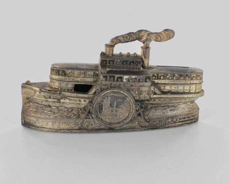 Копилка в виде колесного парохода с медальоном. Начало XX века. Металлический сплав, ткань. Длина 18,8 см, высота - 10,2 см. Западная Европа. https://goskatalog.ru/