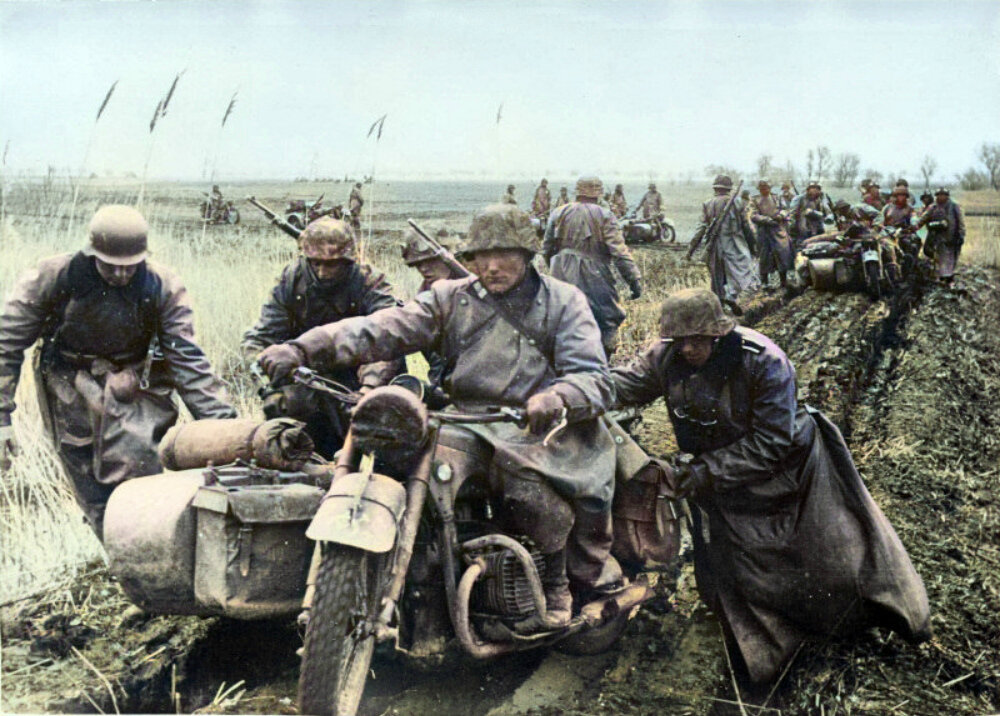 Солдаты войск СС выталкивают мотоцикл из грязи в Югославии. Апрель 1941. Источник: waralbum.ru. Фотография использована в качестве иллюстрации.