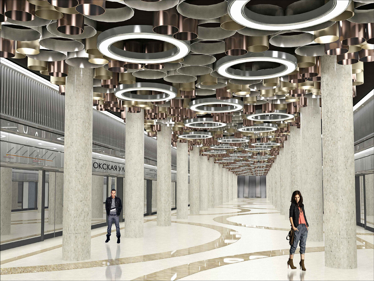 Для начала немного веселых картинок, тем более, что от времени, когда публике показали первые рендеры, до финального варианта, прошло лет шесть. Вот он первый рендер 2012 года. Станция с островной платформой, платформа огорожена стеклянной перегородкой, тогда еще эту идею всерьез рассматривали. Основная фишка станции - это потолок из различных колец в том числе мы видим и светильники в виде колец. Эта идея со светильниками в итоге дожила до реализации.

