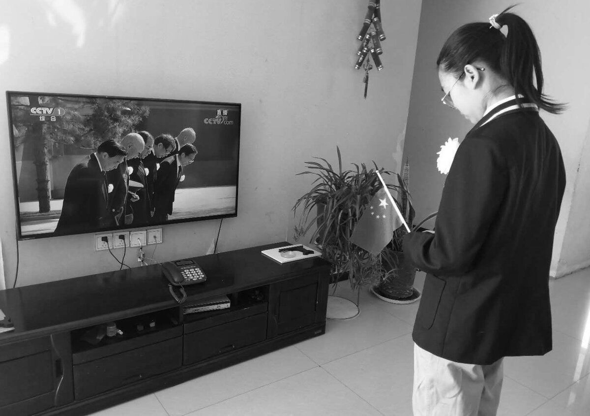 Ученица средней школы в городском округе Лоян склонила голову в память о погибших от новой коронавирусной инфекции.