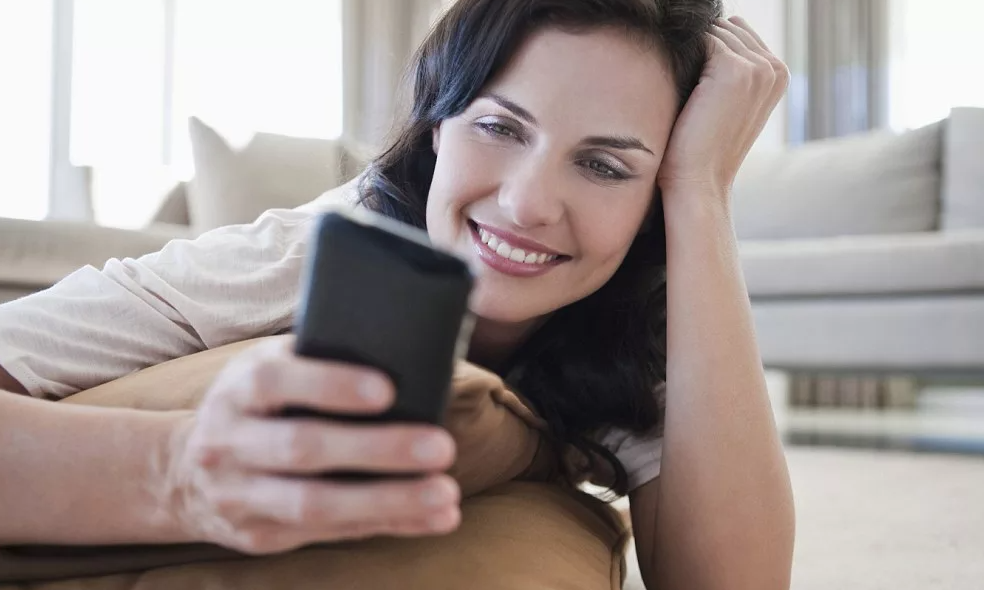 сидит с телефоном в руках. женщина сидиттв телефоне. красивые девушки на телефон. женщина с телефоном. довольная девушка с телефоном.