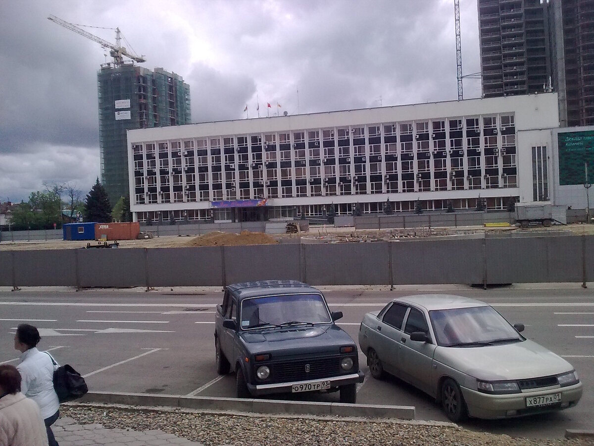 Идет реконструкция площади перед администрацией города. Позади строят Марриот. День. Парковка свободна. 