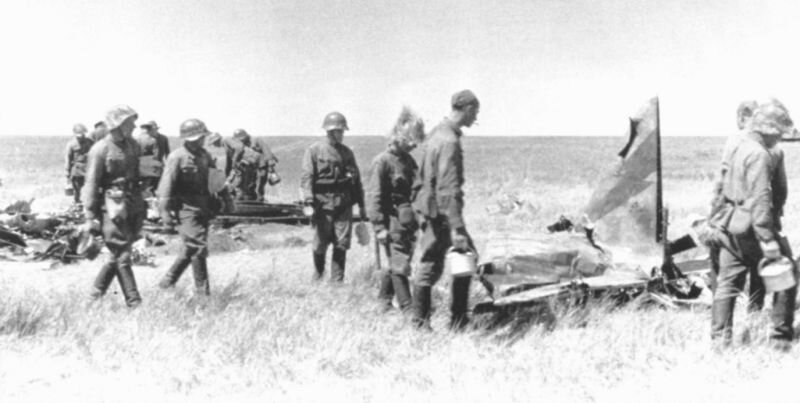 Советские бойцы идут к полевой кухне мимо обломков японского самолёта. 