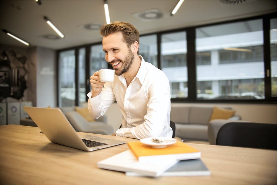 https://www.pexels.com/photo/depth-of-field-photo-of-man-sitting-on-chair-while-holding-cup-in-front-of-table-927451/