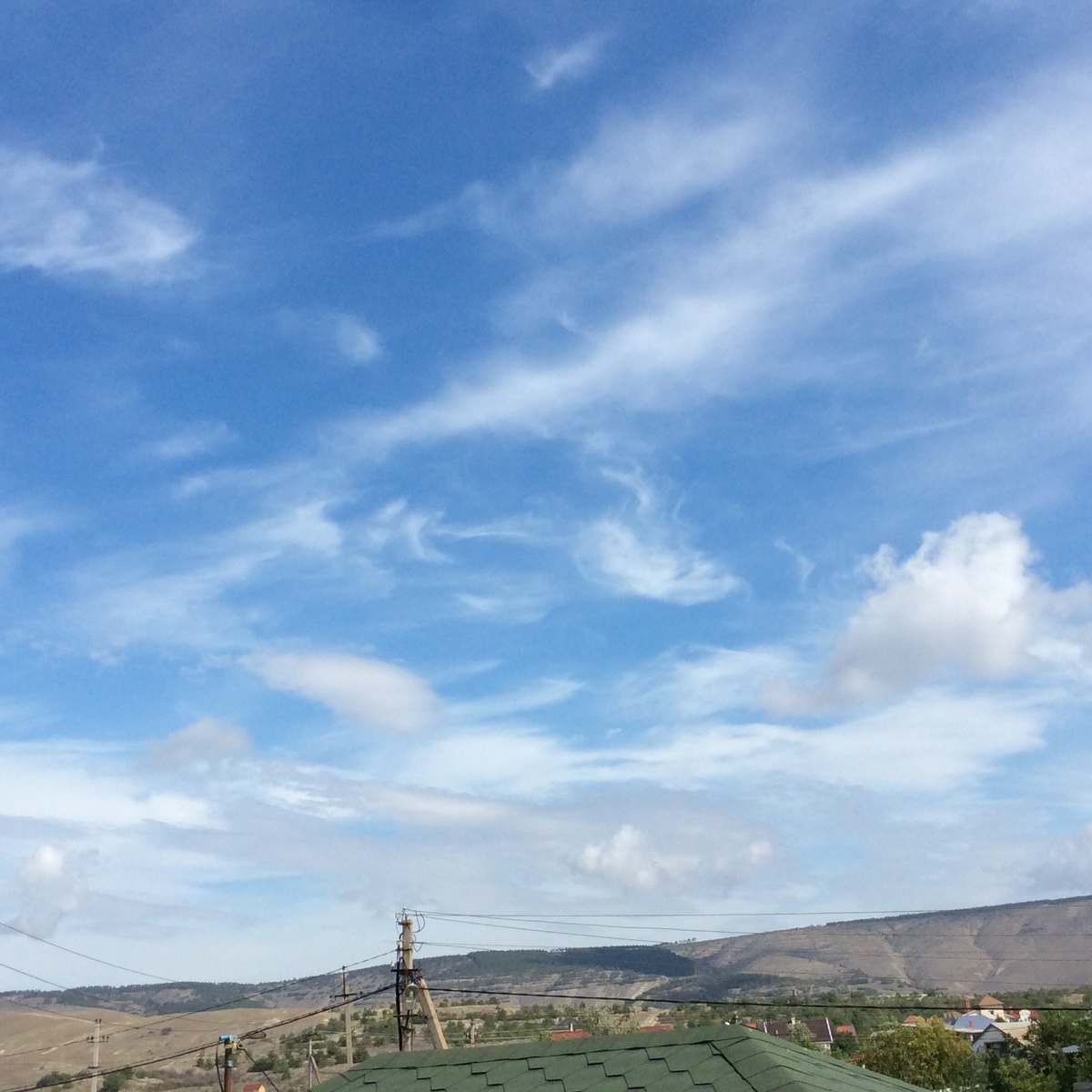 Облака над степью и холмами висят  на одном месте, почти неподвижно
