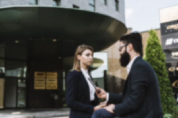 https://image.freepik.com/free-photo/blurred-businesspeople-standing-in-front-of-office-building_23-2147941527.jpg