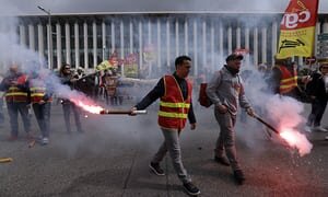  Протестующие держат вспышки во время демонстрации за пределами железнодорожного вокзала Сент-Чарльз, в Марселе, на юге Франции, в среду. Фотография: Клод Париж / AP