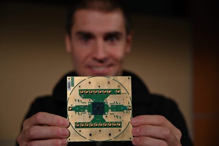 Stefano Pellerano, principal engineer at Intel Labs, holds Horse Ridge. The new cryogenic control chip will speed development of full-stack quantum computing systems, marking a milestone in the development of a commercially viable quantum computer. (Credit: Walden Kirsch/Intel Corporation)