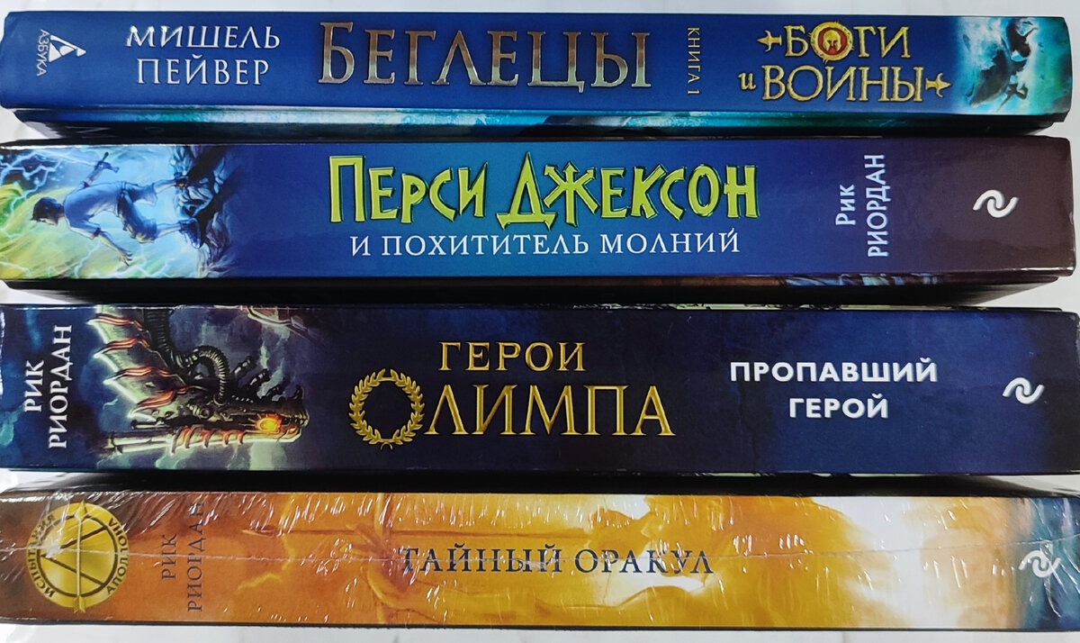 Фото из моей личной коллекции. Публикация фото преследует в информационные цели. На фото книги автора Рика Риордана, издательства Эксмо: "Герои Олимпа. Пропавший герой", "Перси Джексон и похититель молний", "Испытания Аполлона. Тайный оракул". "Боги войны. Беглецы", автор Мишель Пейвер, издательство Азбука. Подробнее о книгах указано в статье.