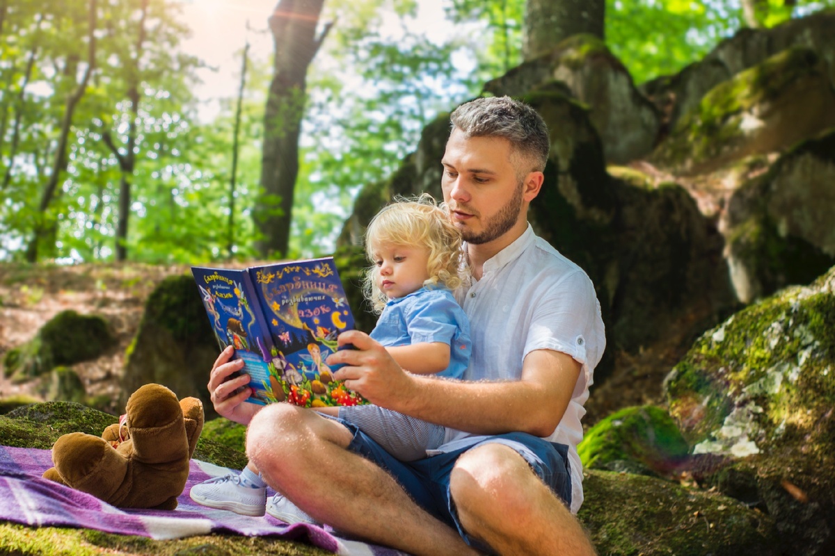 https://www.pexels.com/photo/photo-of-man-and-child-reading-book-during-daytime-2801567/