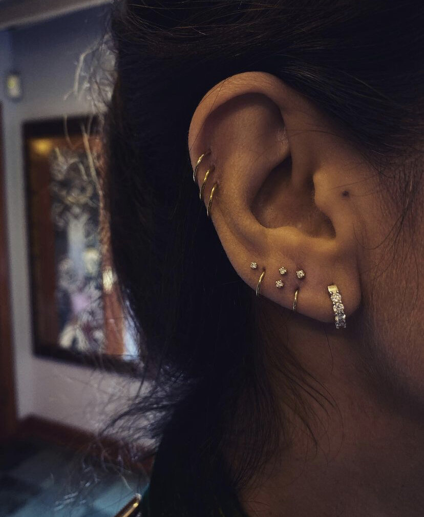 Мини прокол. Ears on the Side with an Earring and a Tattoo.