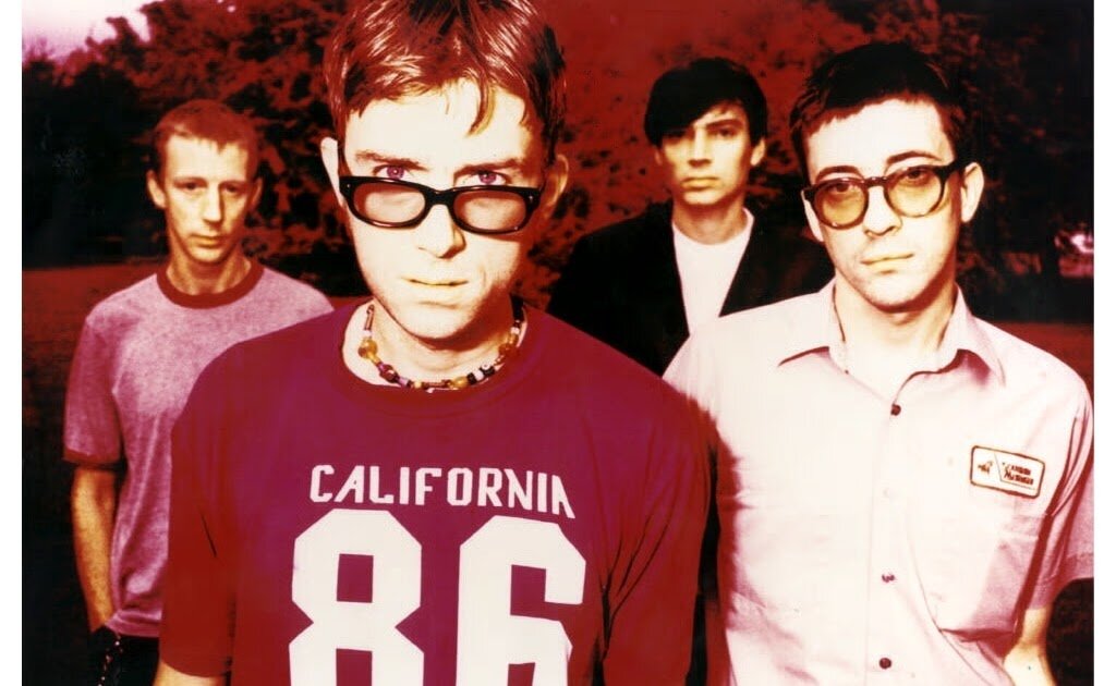 Blur в 1997 году. Слева направо: Дэйв Раунтри (барабанщик), Деймон Албарн (вокалист), Алекс Джеймс (бас-гитарист), Грэм Коксон (гитарист)