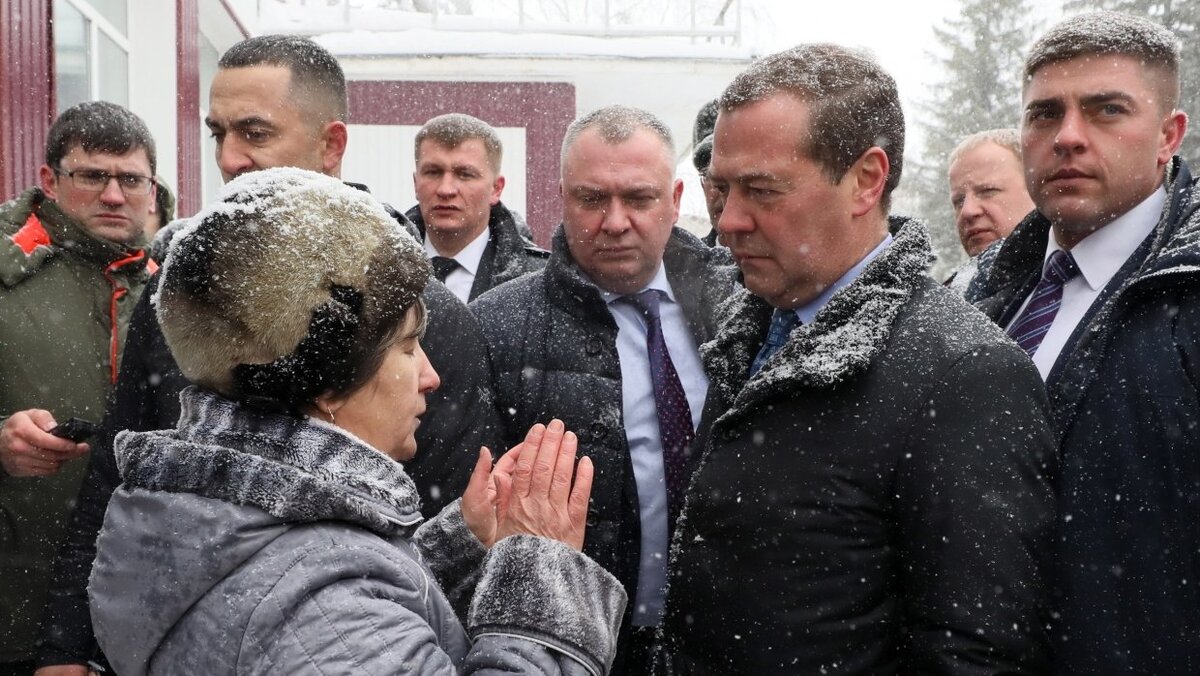 Медведев в окружении охраны общается с пенсионеркой инвалидом