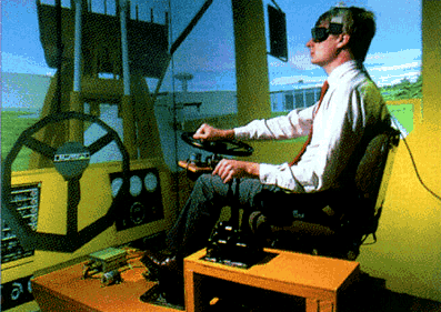 Обучение людей. Эта система CAVE учит людей управлять бульдозером Caterpillar. Рулевое колесо слева встречается с реальным рулевым колесом в виртуальном пространстве (Изображение Fakespace Systems Inc.)