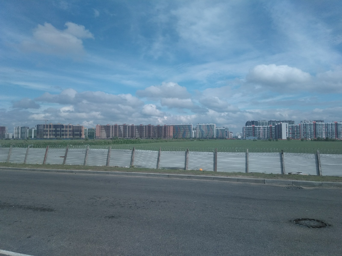 Рядом с домом уже есть автобусная остановка. С нее открывается вид на новостройки и поле. Оно, скорее всего, тоже будет во власти застройщика. И мне почему-то это нравится, чувствуется отдаленность