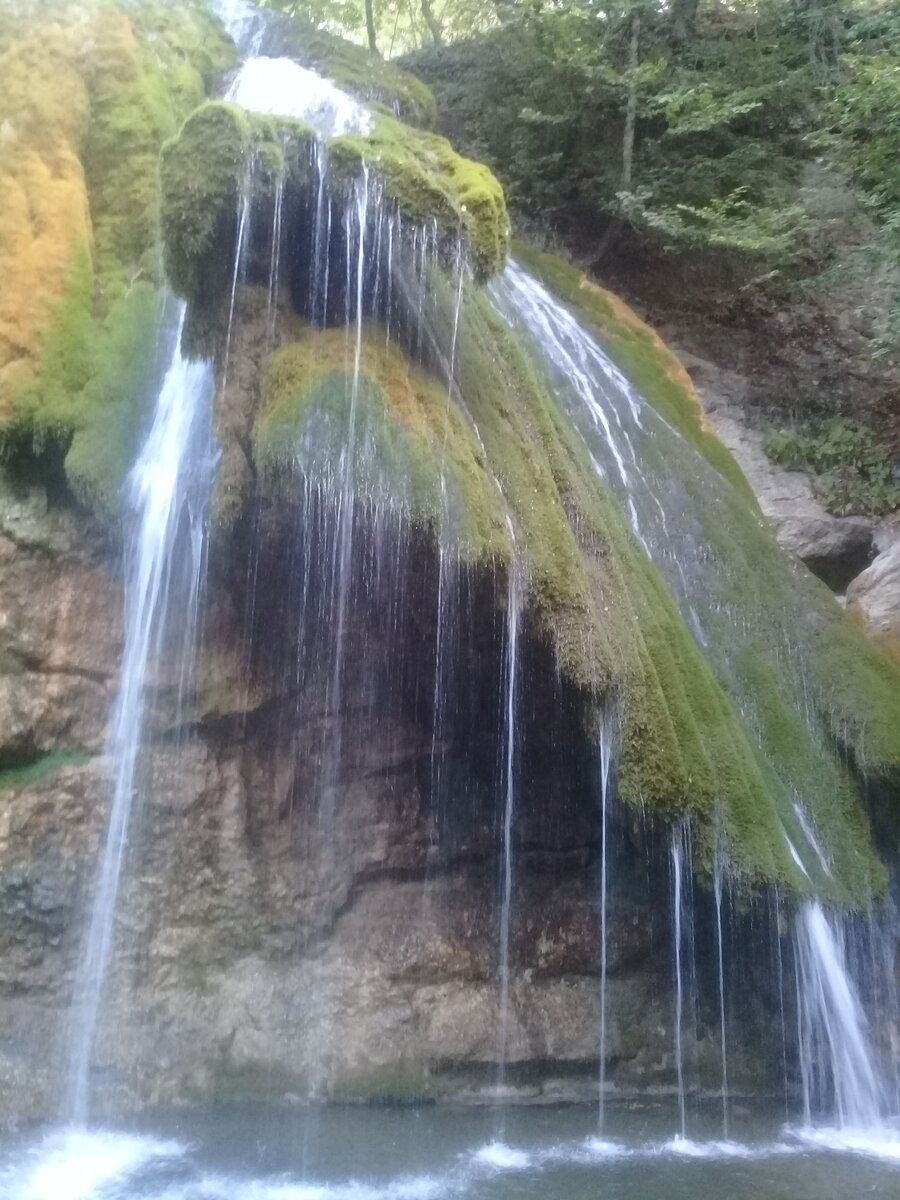 С известнякового уступа, высота которого 15 метров, широким пятиметровым потоком вода обрушивается в глубокий котлован.