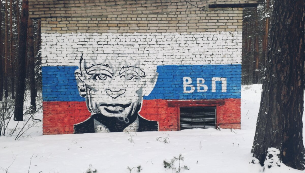 Граффити с портретом Владимира Владимировича путина на фоне триколора .