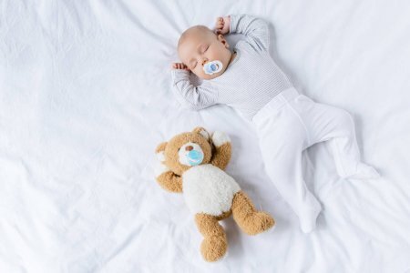 https://st3.depositphotos.com/13185108/16674/i/1600/depositphotos_166741064-stock-photo-sleeping-baby-with-toy.jpg