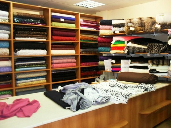 Пристенные стеллажи для тканей можно разместить по всему периметру магазина