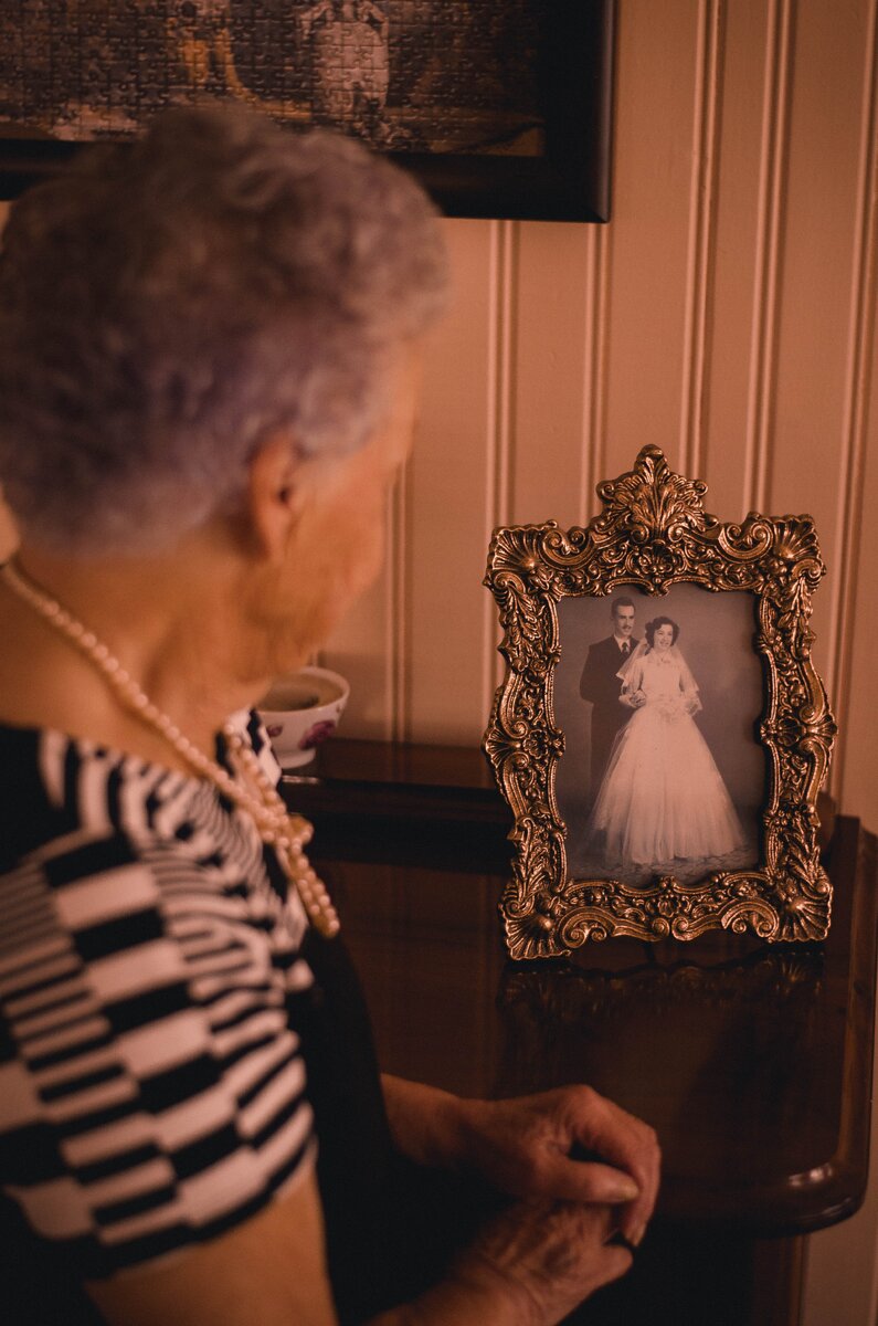 https://www.pexels.com/photo/woman-standing-near-photo-frame-with-newly-wed-couple-picture-2269723/