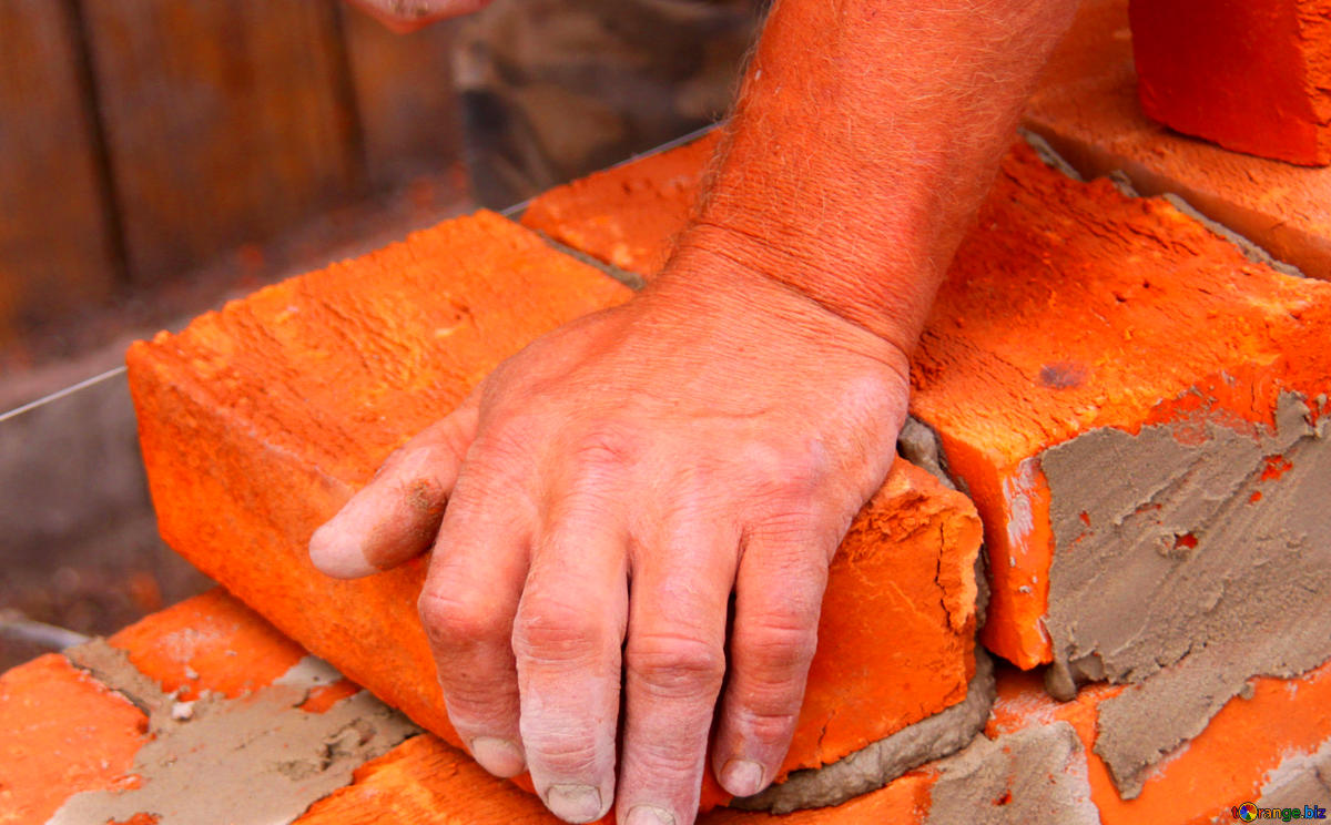 https://torange.biz/photofx/168/8/very-vivid-colours-fragment-mason-hands-building-brick-wall-168481.jpg