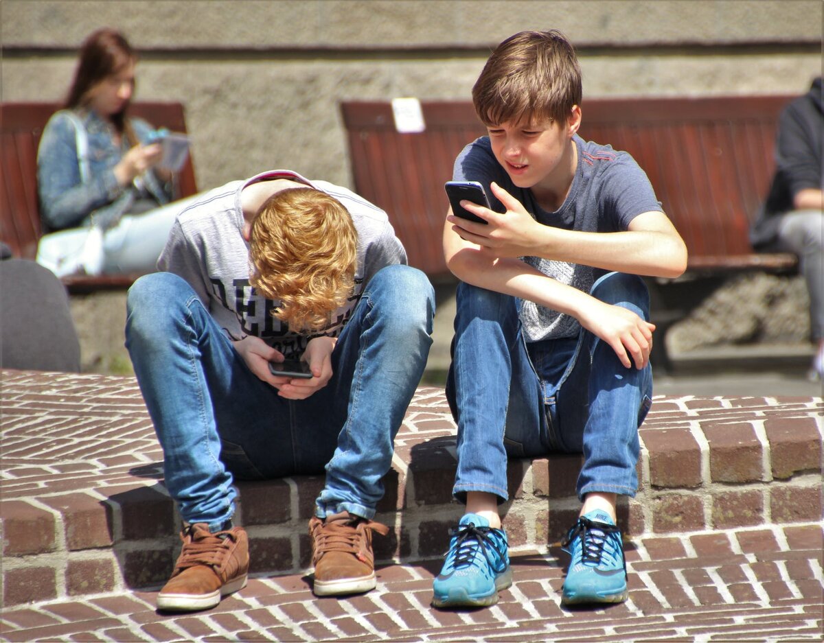 https://www.pexels.com/photo/2-boy-sitting-on-brown-floor-while-using-their-smartphone-near-woman-siiting-on-bench-using-smartphone-during-daytime-159395/
