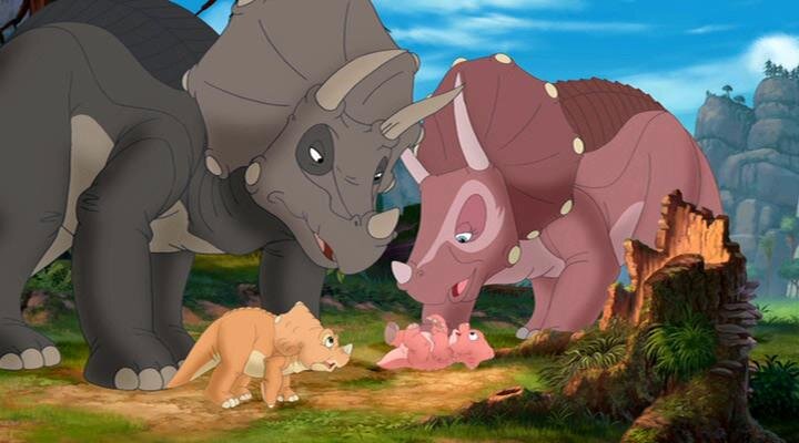 Кадр из мультфильма "Земля до начала времен". Мы видим как две взрослые особи ржут над упавшим малышом, нанося ему психологические травмы.