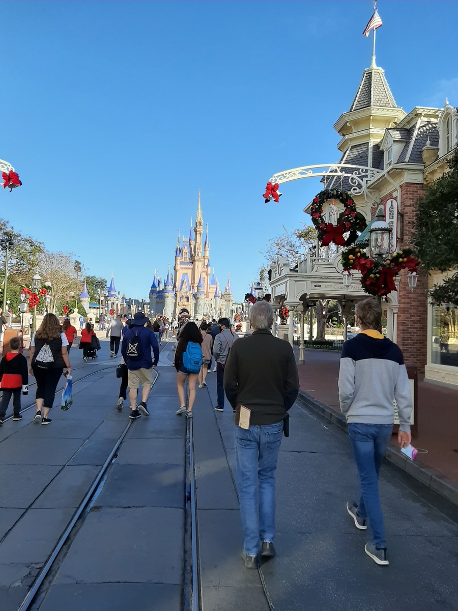 Disney World Magic Kingdom- Диснеевский парк Волшебное Королевство. Посетители движутся от входа по направлению к замку Золушки. Утро 19 Декабря 2020.