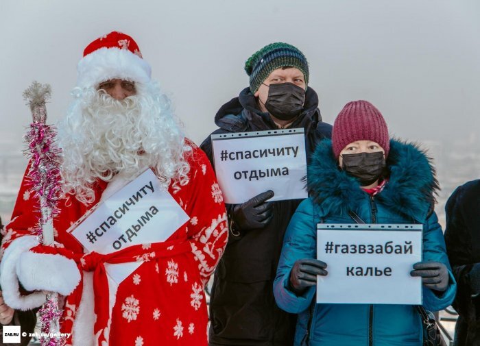 Фото: zab.ru, участники акции сфотографировались на фоне города, укрытого смогом от выбросов ТГК-14 и других загрязняющих источников 