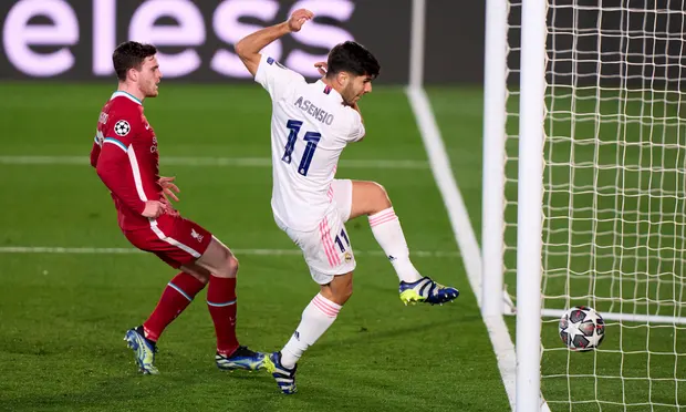 Marco Asensio of Real Madrid scores the second goal against Liverpool after flicking the ball over the Reds goalkeeper Alisson. Photograph: Quality Sport Images/Getty Images
