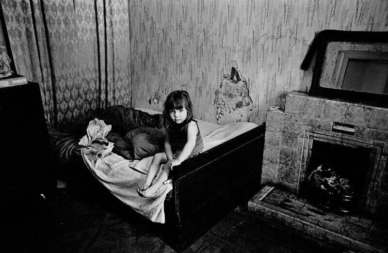 Glasgow, 1970. A child in a damp flat in a semi-derelict block of flats