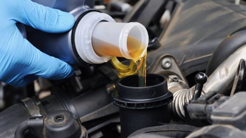 Mechanic doing an oil change on a car