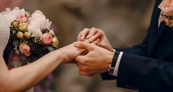 https://www.bonobology.com/wp-content/uploads/2021/04/groom-putting-ring-bride-s-finger-600x320.jpg?ezimgfmt=ngcb3/notWebP