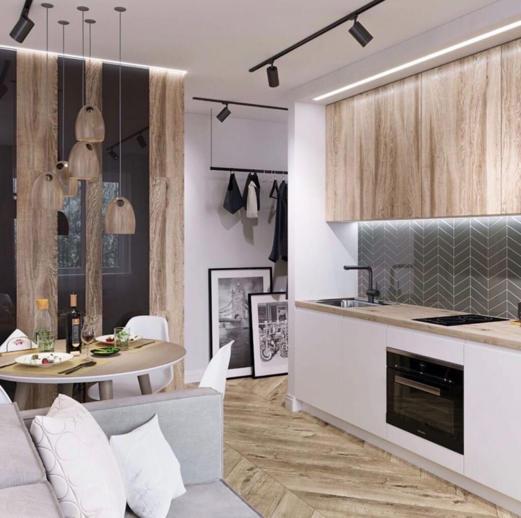 Основа интерьера — серые стены, паркет «елочкой, и монохромная палитра. белые элементы — кухонная мебель, плинтусы, стулья — освежают серую палитру и создают контраст с черными графичными акцентами.