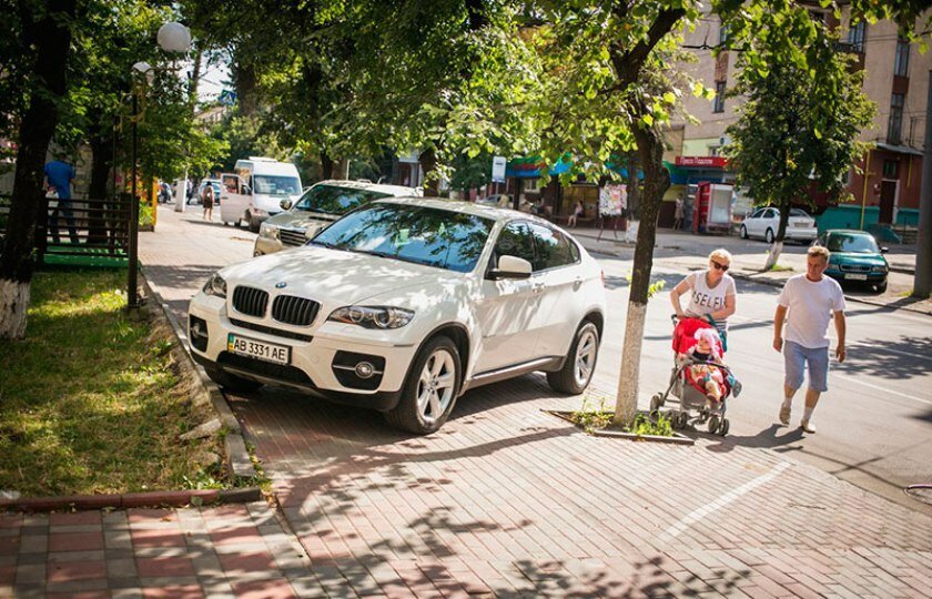 Машина припаркована на тротуаре