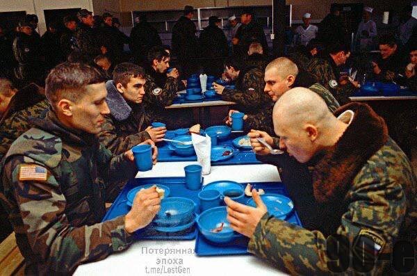 Российские и американские солдаты напротив друг друга в столовке. 

Босния, 1996 год.

