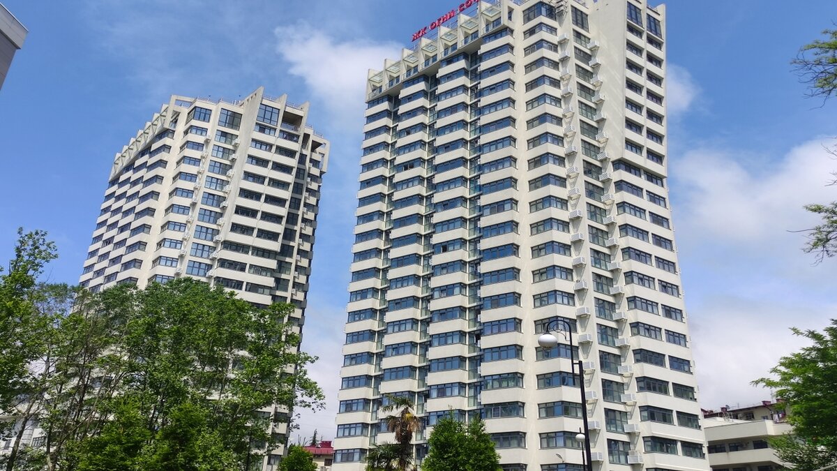 В данном комплексе предоставлены на выбор студии (от 31 кв. м.), 1, 2 и 3-х комнатные квартиры (до 103 кв. м.) с функциональными продуманными планировками. Витражное остекление. Любоваться морским пейзажем можно из большинства квартир обоих корпусов. Каждый из корпусов оборудован 4 современными лифтами. Работает консьерж служба. За исключением автономного отопления (газовая котельная на крыше дома) все коммуникации подведены от городских сетей. На закрытой территории комплекса расположены двухуровневый подземный паркинг, бизнес и торговый центры, где расположены магазины, супермаркеты, кафе, SPA, фитнес-центр и т.д., а также детский сад, зона отдыха, спортивная, детская площадки, озеленение. Рядом есть школа, рынок, супермаркеты, больничный городок, большой торгово развлекательный центр, автобусные остановки. В 300 метрах расположен современная автомобильная магистраль Дублер Курортного проспекта, который быстро позволит добраться в любую точку города. Так, центральный железнодорожный вокзал расположен в 840 метрах, морской порт в 2,3 км, аэропорт в 23 км. Важно отметить, что ЖК Огни Сочи построен по ФЗ-214.