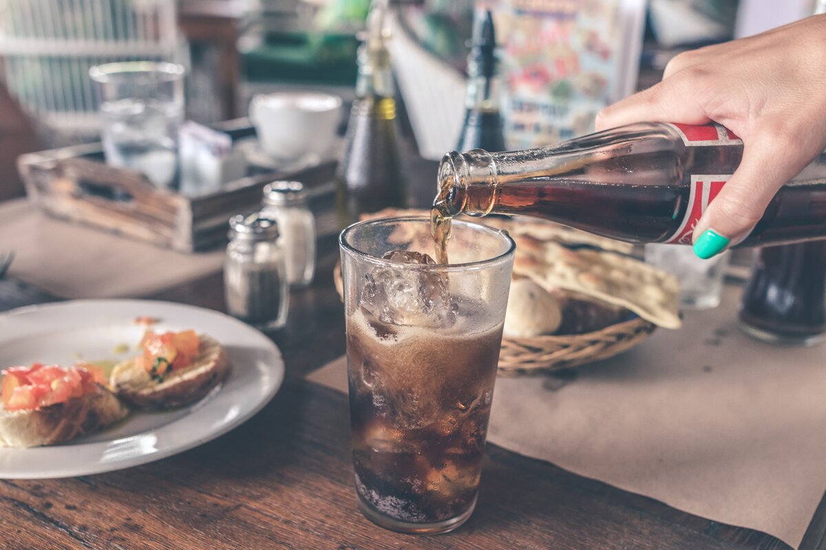 https://www.pexels.com/photo/photo-of-cola-pouring-into-a-glass-with-ice-cubes-926569/