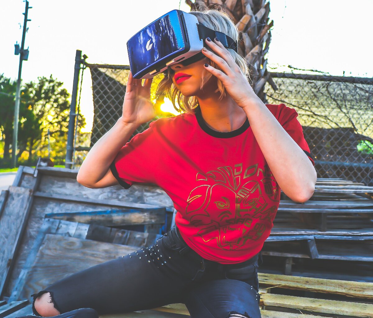 https://www.pexels.com/photo/woman-wearing-red-and-black-top-and-blue-distressed-bottoms-wearing-gray-and-black-virtual-reality-sunglasses-903702/