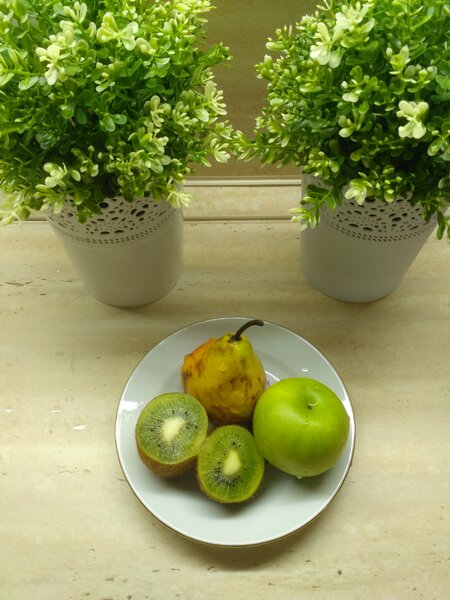 Фотография фруктового перекуса: груша, яблоко и киви на тарелке