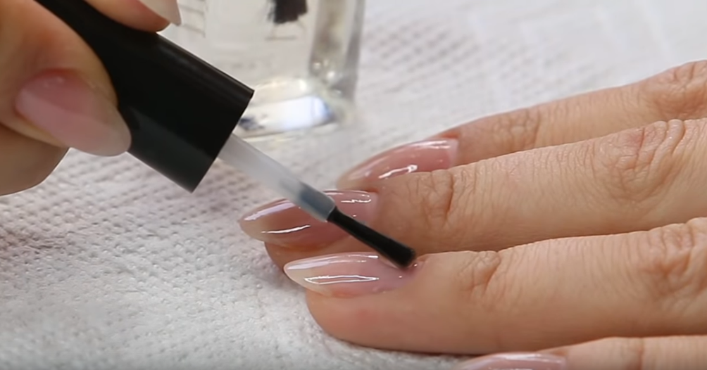 красить ногти прозрачным лаком. девушка красит ногти. крашу ногти бесцветным лаком. руки с маникюром красит бесцветный лак. ногти самостоятельно.